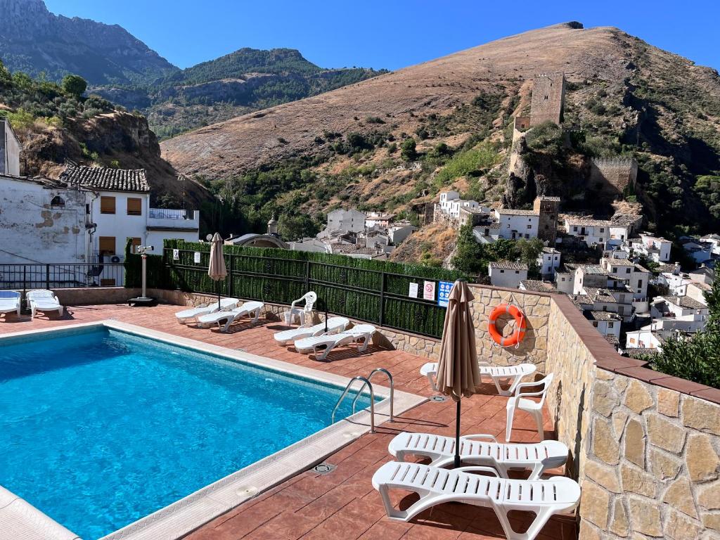 a swimming pool with a view of a mountain at Alojamientos Peña del Rey in Cazorla