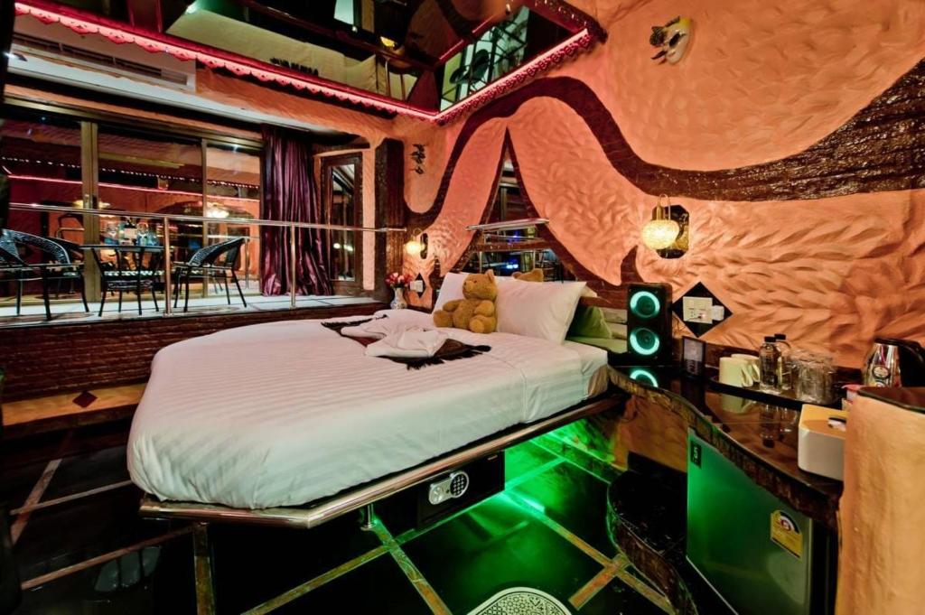 a bedroom with a bed in a room with a bar at PENTHOUSE PATTAYA in Pattaya Central