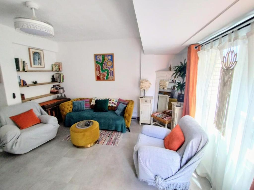 a living room with two chairs and a couch at Double Room with Private bathroom in Luxury Boho Chic Shared Apartment in Denia