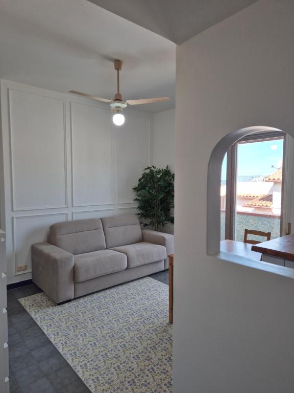 a living room with a couch and a mirror at Al Belvedere di San Nicola Arcella in San Nicola Arcella