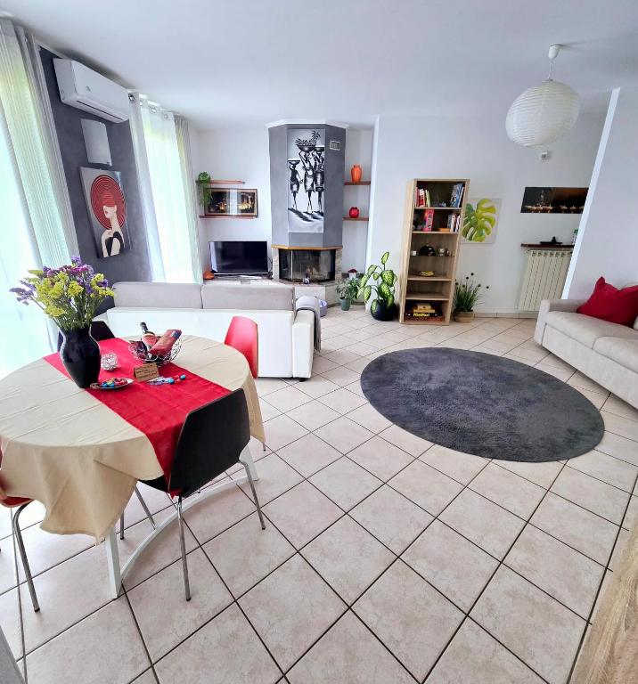 a living room with a table and a couch at ZARA HOUSE - Lake and Pet Friendly in Brusimpiano