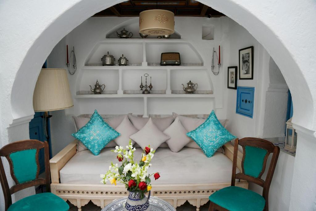 a living room with a couch and chairs and a table at Riad Cherifa in Chefchaouene