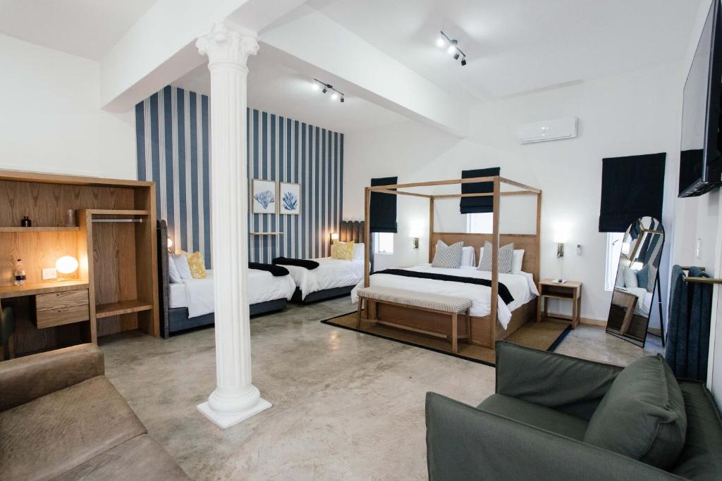 Ένα ή περισσότερα κρεβάτια σε δωμάτιο στο The Palms Boutique Hotel