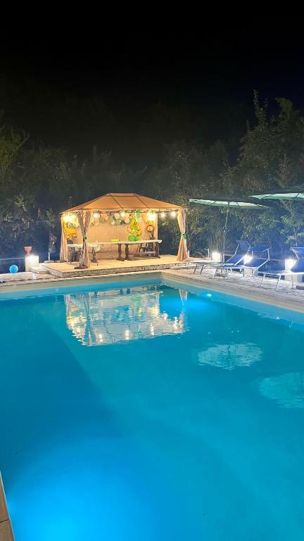 a large swimming pool at night with a gazebo at La Collina Dei Castagni in Terni