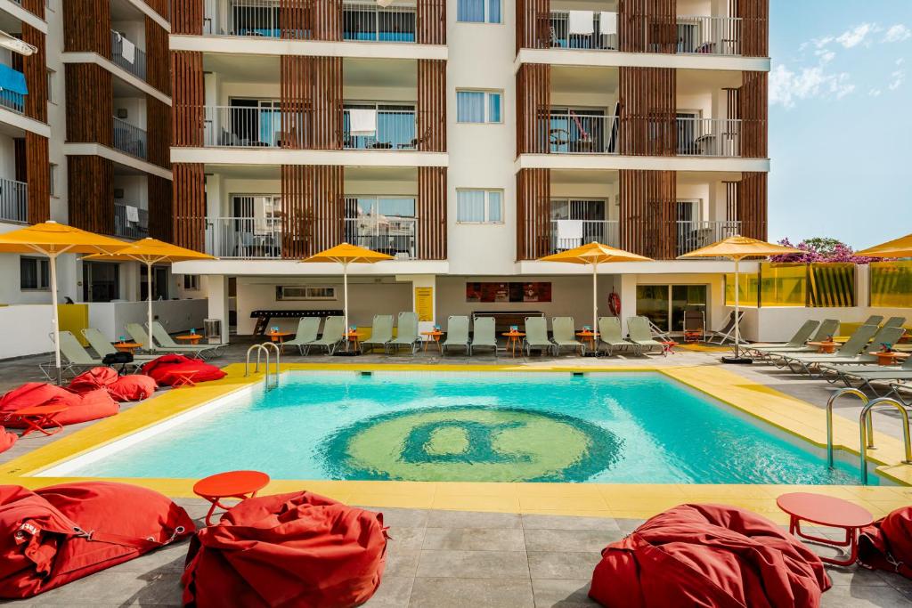 a swimming pool in front of a hotel at Ryans Ibiza Apartments - Only Adults in Ibiza Town