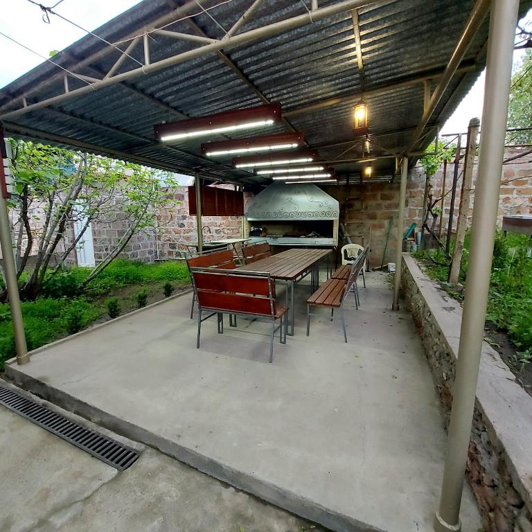 a patio with a grill and a table and chairs at Komfort in Aghk'ilisa