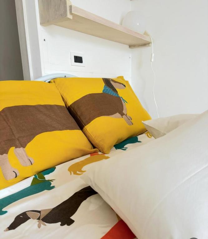 a bedroom with a bed with a yellow pillow at PURA B&b in Noicattaro