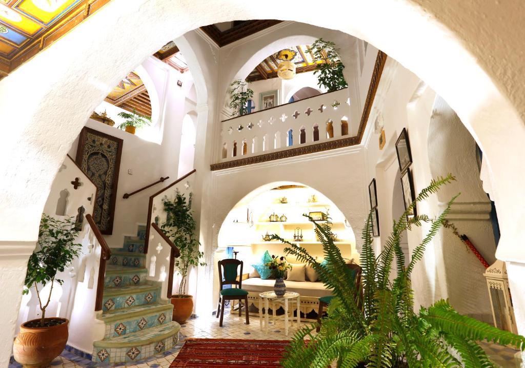 an archway in a building with a table and chairs at Riad Cherifa in Chefchaouene