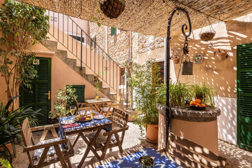 an outdoor patio with a table and chairs at Can Busquets - Tramuntana Suite in Banyalbufar