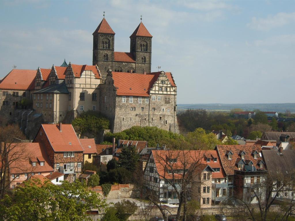 a large castle sits on top of a city at Ferienhaus Münzenberg 53 in Quedlinburg