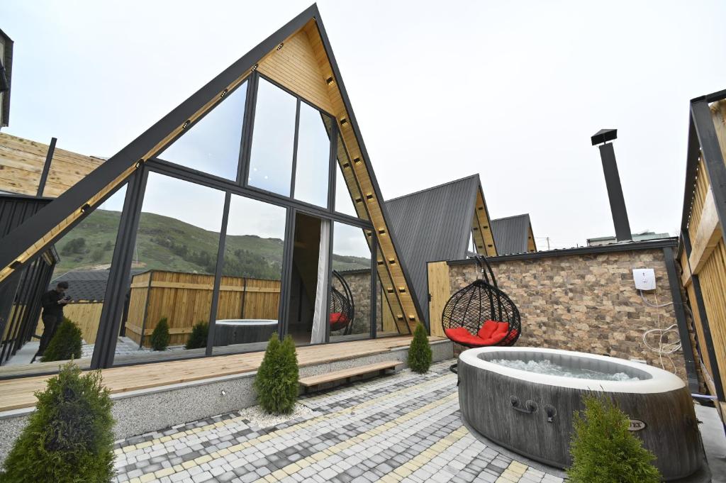 a house with a large tub on the roof at Avra Resort Tsaghkadzor in Tsaghkadzor