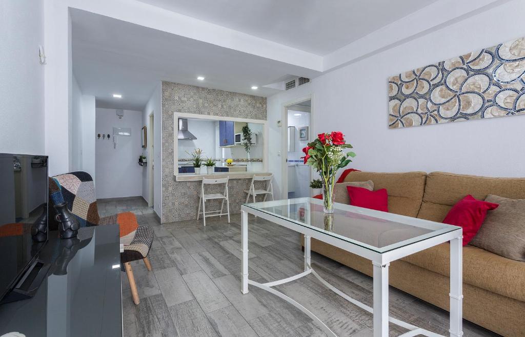 a living room with a couch and a table at Apartamentos Collado Playa Valdelagrana in El Puerto de Santa María