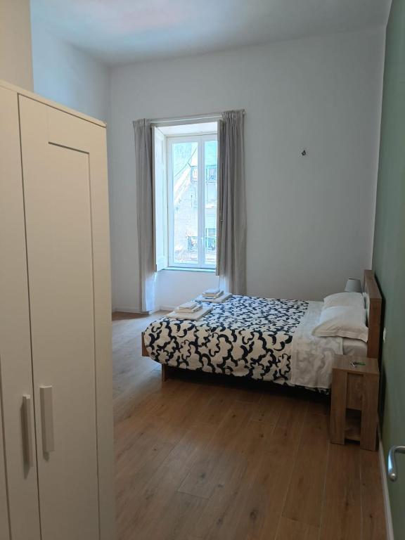 a bedroom with a bed and a window at Residence e appartamenti Rosaroll in Naples