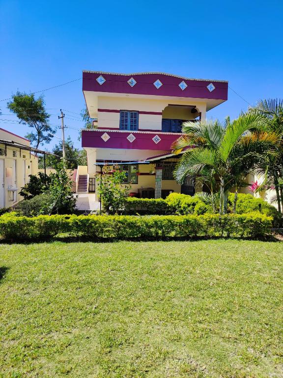 a building with a lawn in front of it at Valley View by Green Trails in Chikmagalūr