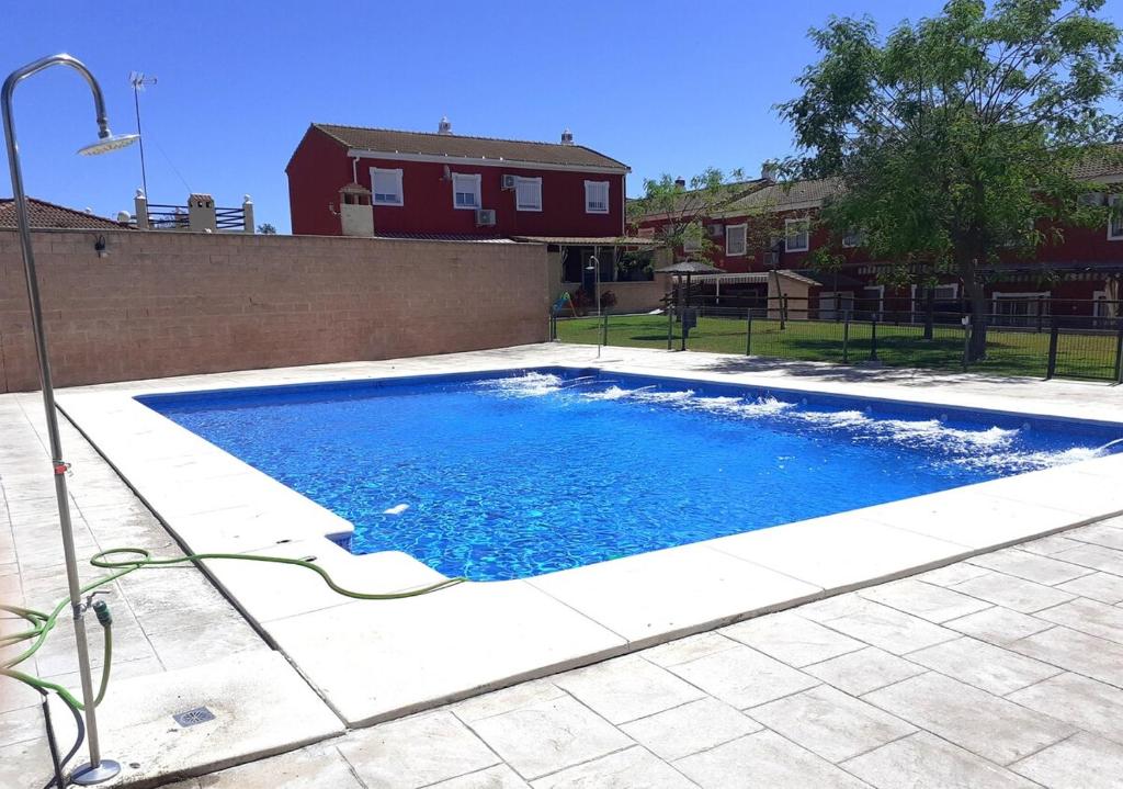 a swimming pool with blue water in a yard at Casa El Garrobo in El Garrobo