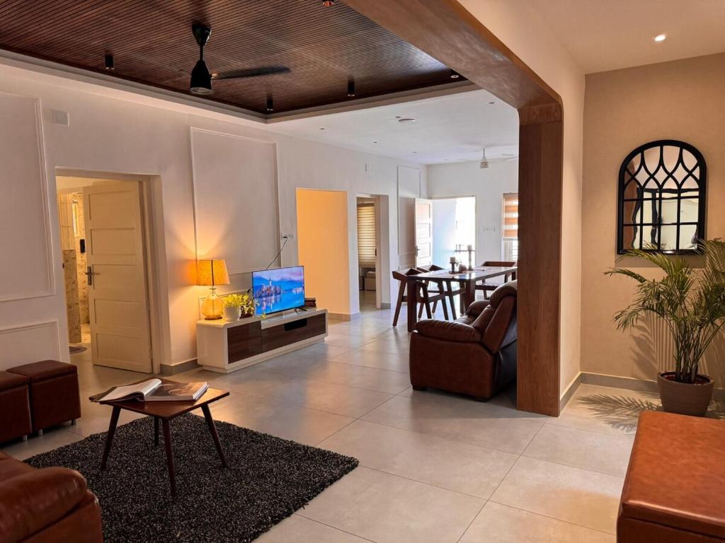 a living room with a couch and a table at Stay Central Loft Panampilly in Cochin