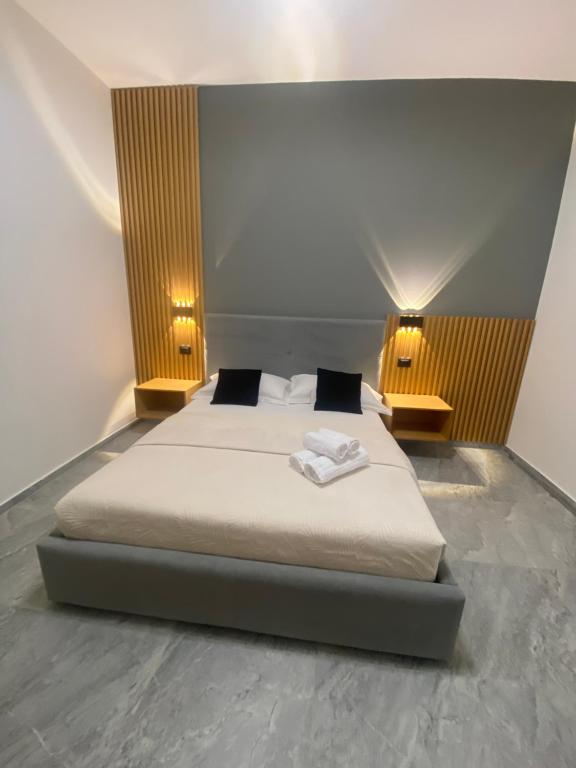 a bedroom with a bed with two lamps on it at La casa della stazione in La Spezia