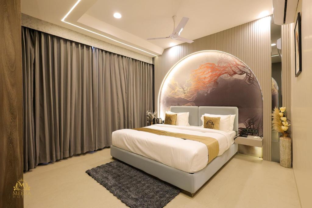 a bedroom with a large bed with a large globe on the wall at The Meera Hotel in Ujjain