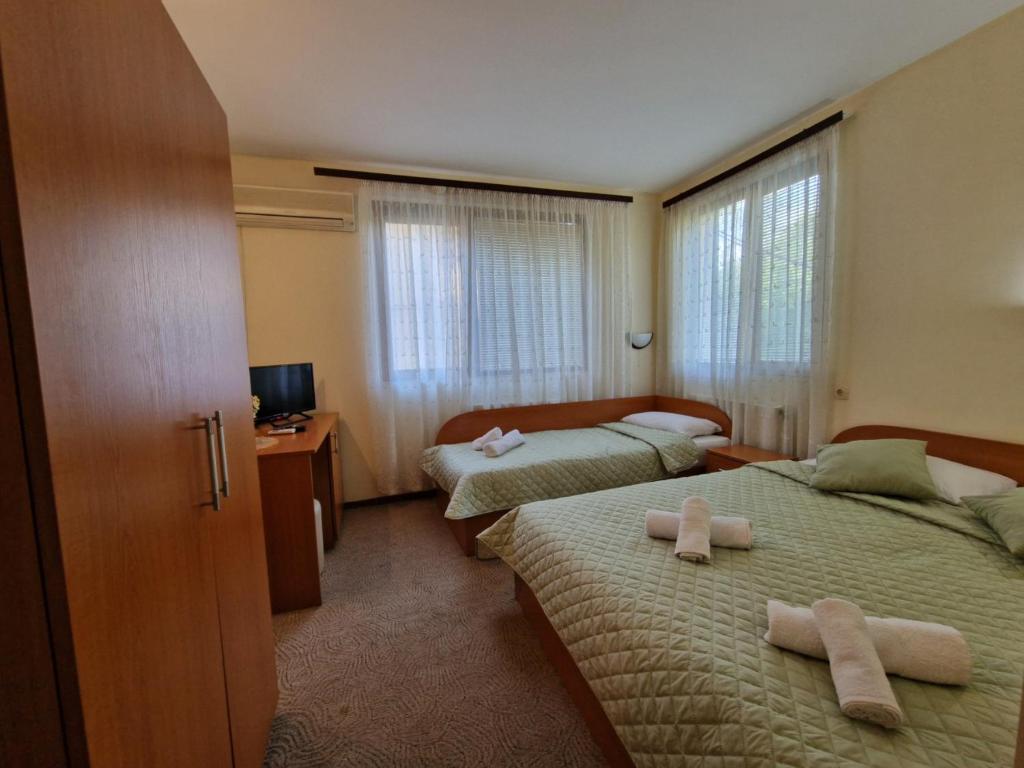 Postel nebo postele na pokoji v ubytování Rebeka Guest House