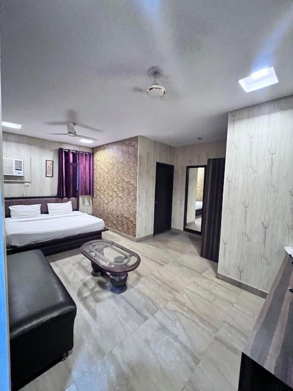 a living room with two beds and a couch at Hotel Airport residency in Jaipur