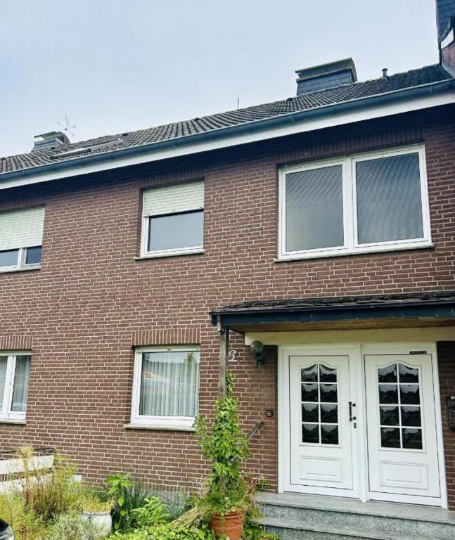 a brick house with white doors and windows at Wohnung für Monteure in Ahlen