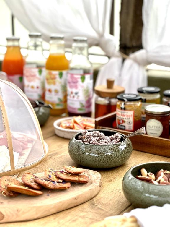 a table topped with bowls of food and other ingredients at Hôtel Palombaggia in Porto-Vecchio