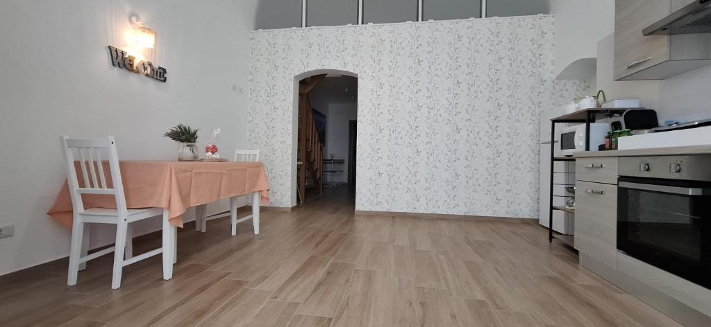a kitchen with a table and a dining room at vanilla house in Molfetta