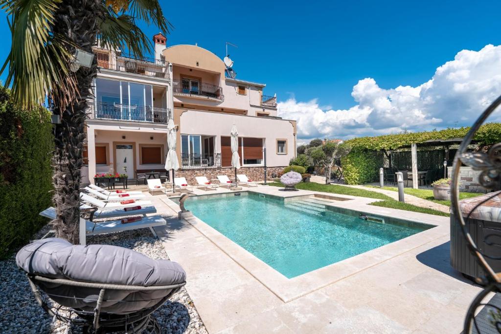 a villa with a swimming pool and a house at Evan by Briskva in Poreč