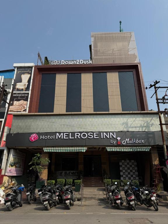a building with motorcycles parked in front of it at Hotel Melrose Inn - Near Railway Station , Aligarh in Alīgarh