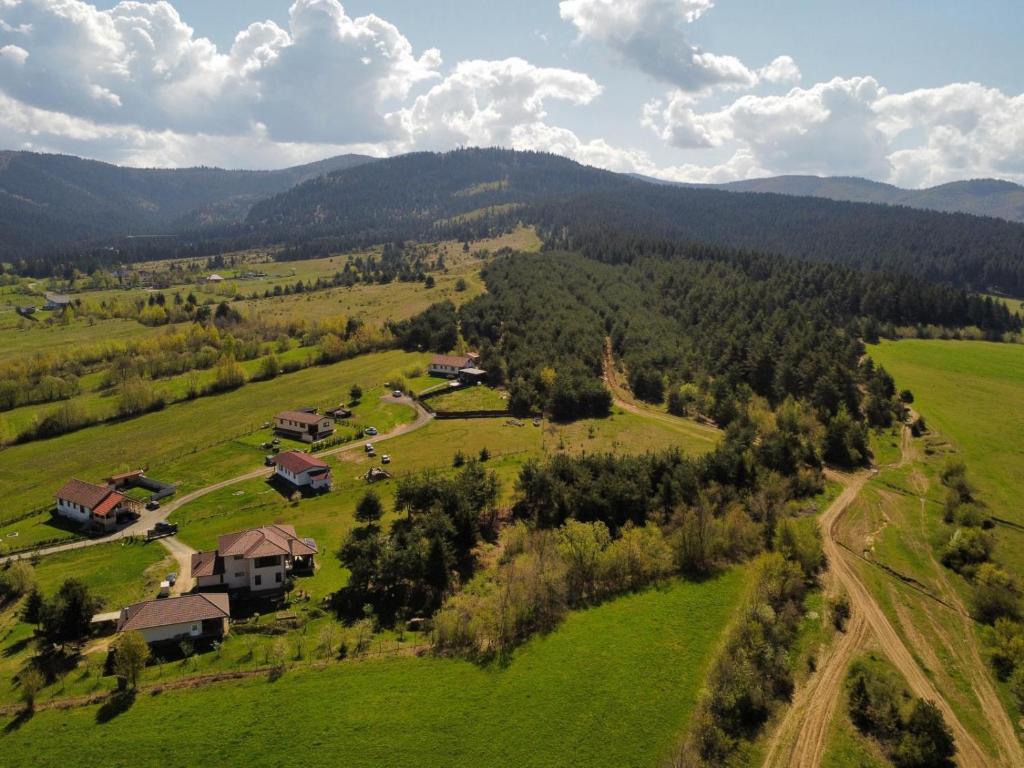 an aerial view of a house in a green field at Forest Hide Tiny House in Covasna