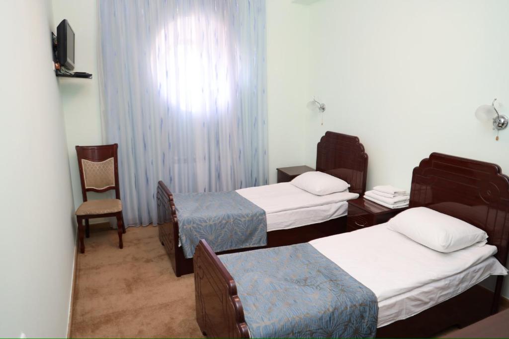 Postel nebo postele na pokoji v ubytování Syuniq Hotel