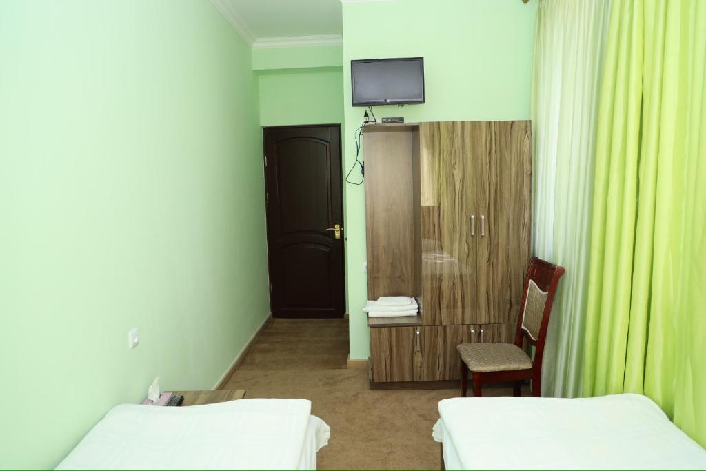 Postel nebo postele na pokoji v ubytování Syuniq Hotel