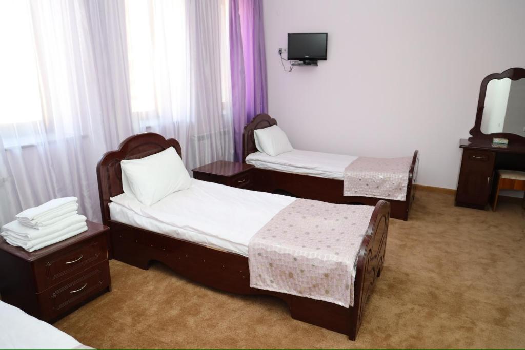 Postel nebo postele na pokoji v ubytování Syuniq Hotel