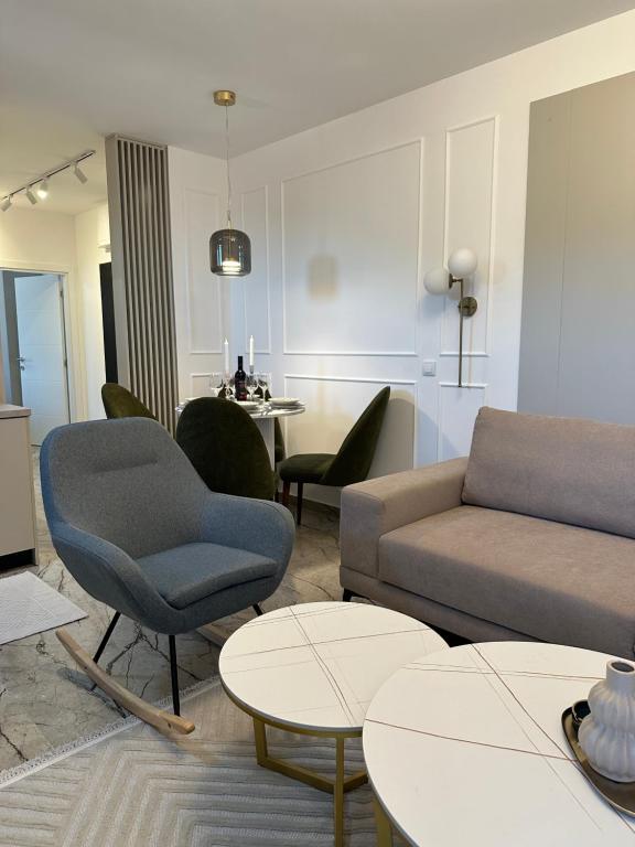 a living room with a couch and chairs and tables at Mila apartman Banja Koviljaca in Banja Koviljača