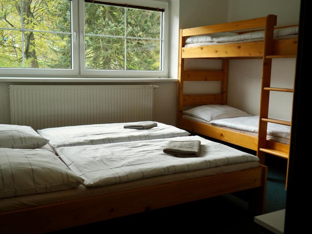 Postel nebo postele na pokoji v ubytování Penzion Kouty