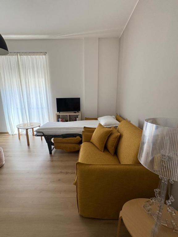 a living room with a couch and a bed at Verde Acqua Suite in Lecco