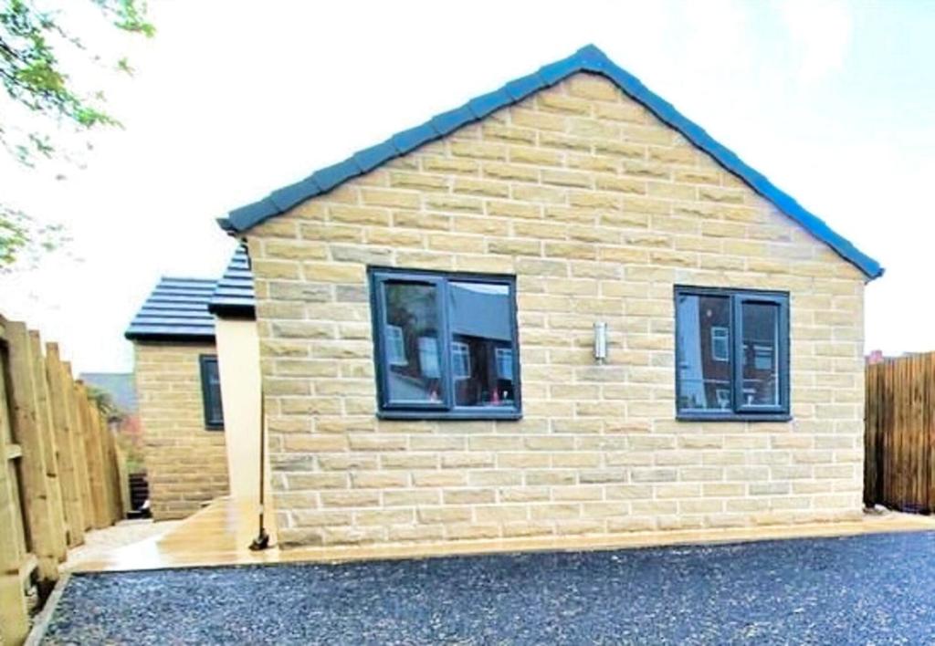 a brick house with two windows on a driveway at 2 Bed Sleeps 4 Pet Friendly Free Parking in Rotherham