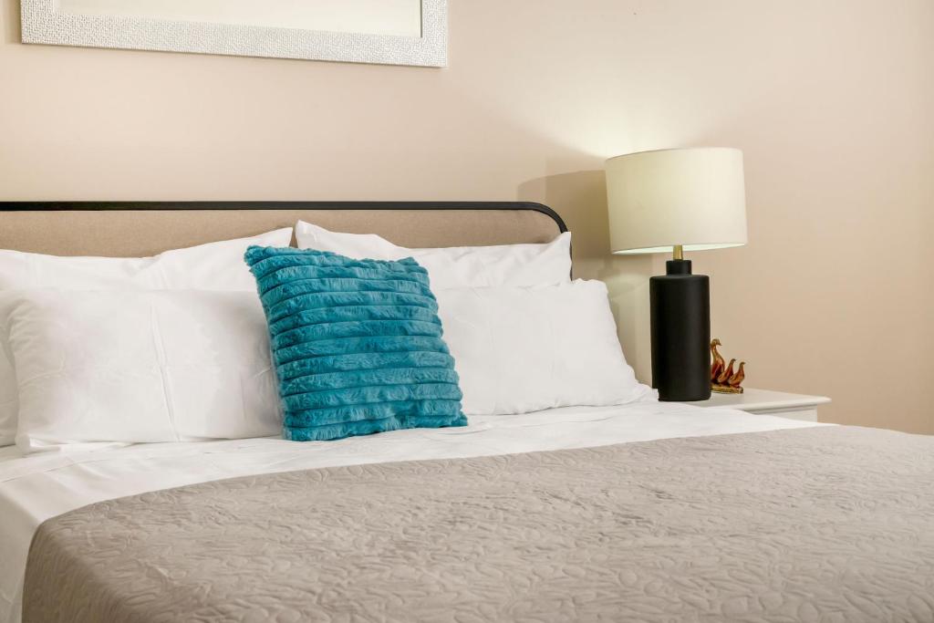 a blue pillow sitting on top of a bed at Fairview Near AC Hotel Kingston - FIWI in Kingston