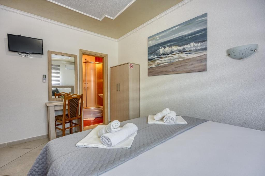 Postel nebo postele na pokoji v ubytování Stipe Rooms