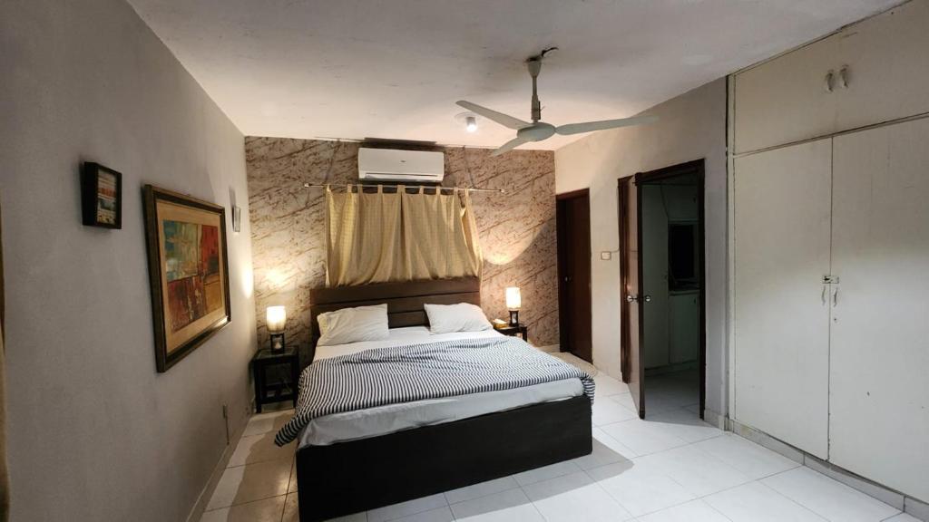 a bedroom with a bed in a room at Karachi cozy corner in Dargai