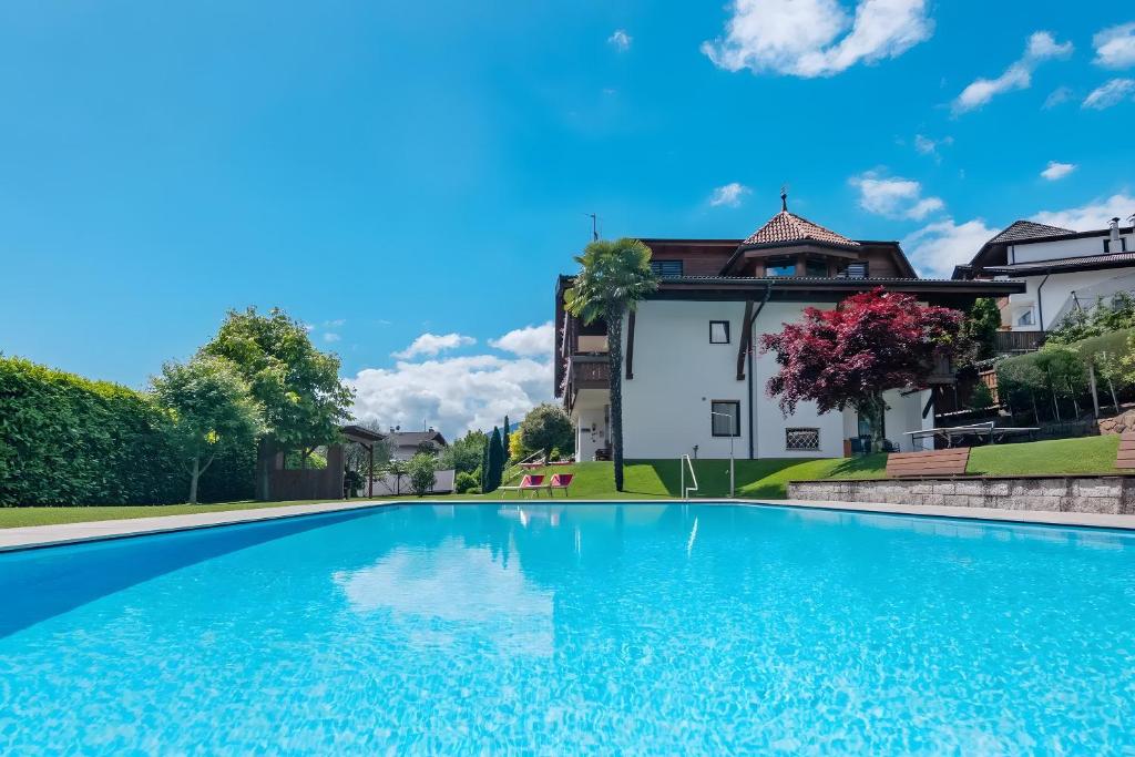 a swimming pool in front of a house at Haus Christine in Rifiano