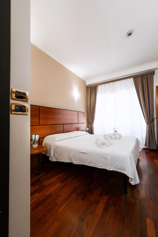 Postel nebo postele na pokoji v ubytování Hotel City Center