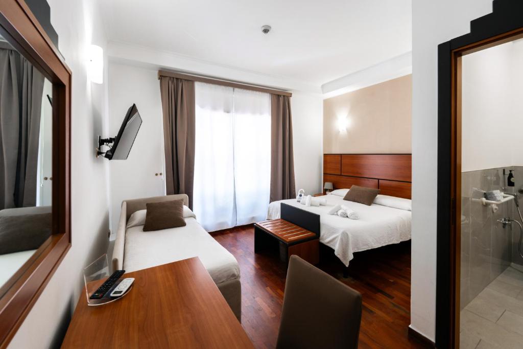 Postel nebo postele na pokoji v ubytování Hotel City Center