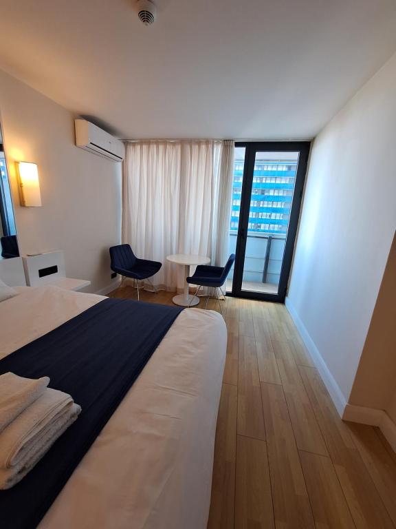 a hotel room with a bed and a large window at Orbi City rooms 1039 in Batumi