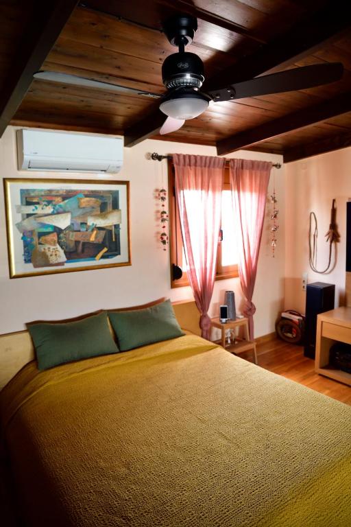 a bedroom with a bed and a ceiling at Panoramic deluxe penthouse in Thérissos