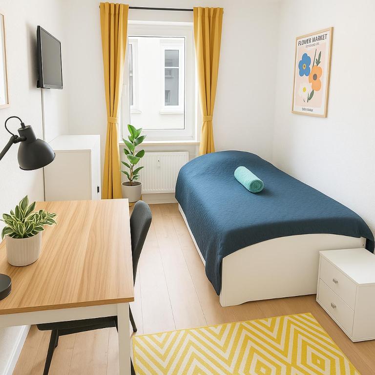 a bedroom with a bed and a table and a desk at Ressel Mansion in Bitterfeld