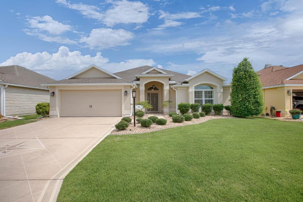 a large house with a grass yard at 1987 Z3a Village of Pennecamp by REMAX Premier in The Villages