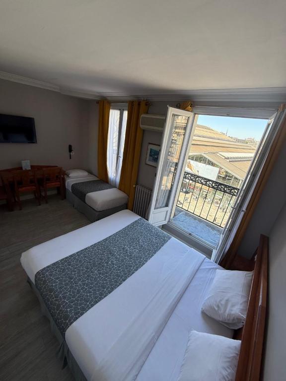 Cama o camas de una habitación en New Hôtel Gare Du Nord