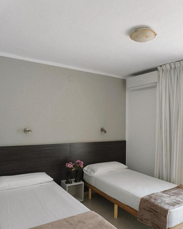 Postel nebo postele na pokoji v ubytování Hotel Ram Rooms Tahiti