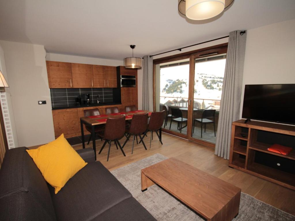 a living room with a couch and a table at Charmant appartement neuf avec balcon, 2 chambres, 2 SDB et parking au cœur des Saisies - FR-1-293-272 in Hauteluce